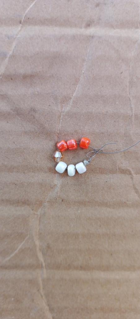 Accessories, Earring, Jewelry, Bead, Necklace, Box, Gemstone, Pebble, Food, Sweets, Cardboard, Carton, Produce, Rock, Ornament, Bead Necklace, Medication, Leaf, Plant, Fruit, Candy, Sphere, Grain, Floor, Wood, Ball, Golf, Golf Ball, Sport, Pill, Agate, Prayer, Prayer Beads, Crystal, Nature, Outdoors, Green, Pearl, Weather, Bracelet