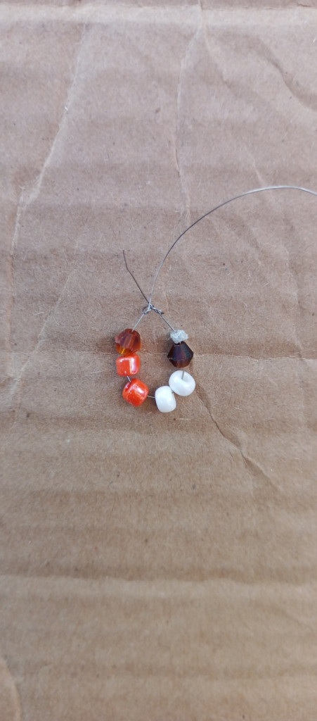 Accessories, Earring, Jewelry, Bead, Necklace, Gemstone, Sphere, Box, Ornament, Cardboard, Wood, Bead Necklace, Carton, Prayer, Prayer Beads, Food, Sweets, Ball, Golf, Golf Ball, Sport, Pebble, Floor, Coil, Spiral, Produce, Nature, Outdoors, Flooring, Bracelet, Pearl, Grain, Collar, Agate, Silver, Fruit, Plant, Crystal, Pin, Animal, Invertebrate, Sea Life, Seashell