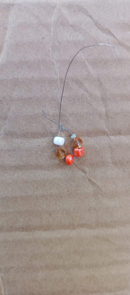 Accessories, Earring, Jewelry, Necklace, Bead, Gemstone, Food, Produce, Box, Wood, Ornament, Cardboard, Fruit, Plant, Carton, Sweets, Outdoors, Sphere, Agate, Pendant, Animal, Bead Necklace, Floor, Grain, Home Decor, Linen, Nut, Vegetable, Seed, Coil, Spiral, Back, Body Part, Person, Invertebrate, Sea Life, Seashell, Citrus Fruit, Grapefruit, Leaf, Flooring, Pebble, Crystal, Nature, Collar, Pin, Opal, Cat, Mammal, Pet, Spider, Prayer, Prayer Beads