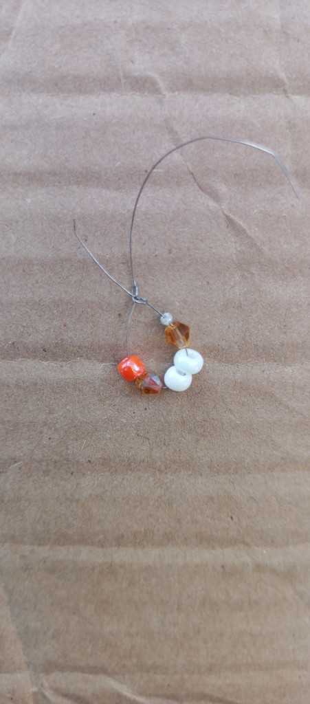 Accessories, Earring, Jewelry, Necklace, Gemstone, Bead, Animal, Invertebrate, Sea Life, Seashell, Food, Sweets, Produce, Ornament, Outdoors, Pebble, Cardboard, Fruit, Plant, Nature, Grain, Flower, Seed, Box, Petal, Spider, Mineral, Wood, Beak, Bird, Crystal, Sphere, Agate, Carton, Clam, Seafood, Bead Necklace, Nut, Vegetable, Coin, Money, Floor, Cat, Mammal, Pet, Sand, Citrus Fruit, Grapefruit, Rock, Paper, Candy, Back, Body Part, Person, Leaf, Bud, Sprout, Coil, Spiral, Flooring, Weather, Balloon, Soil, Pearl, Clothing, Pants