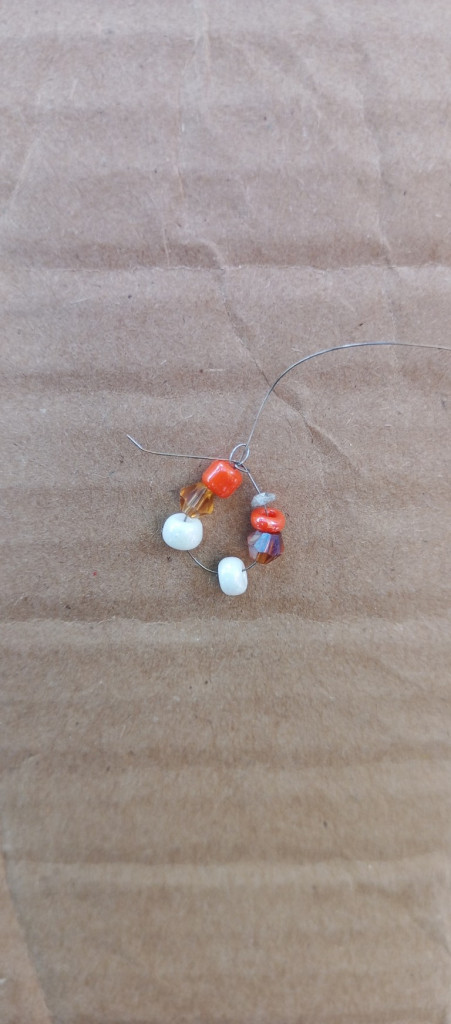 Accessories, Earring, Jewelry, Bead, Gemstone, Food, Sweets, Ornament, Necklace, Cardboard, Nature, Outdoors, Box, Candy, Ball, Golf, Golf Ball, Sport, Carton, Sphere, Medication, Crystal, Wood, Produce, Pebble, Grain, Animal, Soil, Bead Necklace, Agate, Coil, Spiral, Floor, Weather, Prayer, Prayer Beads, Opal, Pill, Flooring, Back, Body Part, Person, Strap, Sand, Mineral, Rock, Invertebrate, Sea Life, Seashell, Collar, Leaf, Plant, Bean, Vegetable